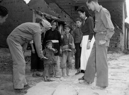 Chaplain Mengel lead his men to participate in outreach to the wartorn and impoverished Chinese countryside. These photos from Chaplain Mengel's private collection, show him with General Chennault, giving out donations from the US airmen.