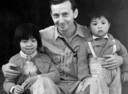 Eugene Wozniak, a combat photographer who served in the CBI, as part of the 491st Bomb Squadron, with two Chinese children during WWII.