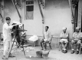 Local Indian photographer at work.  Scenes in India witnessed by American GIs during WWII. For many Americans of that era, with their limited experience traveling, the everyday sights and sounds overseas were new, intriguing, and photo worthy.