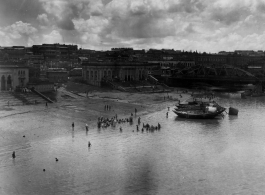 Fancy buildings alongside a river.  Scenes in India witnessed by American GIs during WWII. For many Americans of that era, with their limited experience traveling, the everyday sights and sounds overseas were new, intriguing, and photo worthy.