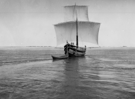 Boat with sails on a river in India.  Scenes in India witnessed by American GIs during WWII. For many Americans of that era, with their limited experience traveling, the everyday sights and sounds overseas were new, intriguing, and photo worthy.