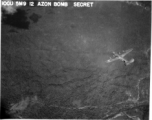 IOCU 5MP 12 AZON BOMB SECRET. A B-24 bomber flying a mission.  According to this photograph's header, it may be carrying an AZON.