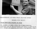 Leonard S. Jordan of the Chinese-American Composite Wing (CACW) hangs a sign indicating the "Photo Section," in both English and Chinese.  照相室，中美联合大队。