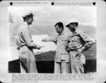 Capt. Joseph Norton, chief CACW Weather Officer, and Sgt. Jack Barishman discuss the approach of a "front" with Chinese Weather Officier, Capt. Y. H. Wei.