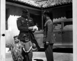 Chennault receives a bundle of Christmas greeting from China's children at the hand of his Chief Interpreter, Col. P. Y. Chu.