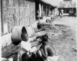 A little roadside barbering in the CBI, either Burma or India.