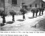 Women carrying bundle of straw or brush at the rest camp at Ranikhet in 1944, high in Himalayan mountain range of India. During WWII.