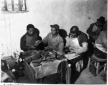 Chinese cobblers working on shoes. In the CBI during WWII.   Photo by Syd Greenberg.