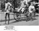 Sgt. Bob Travis Keagle shows his camera to a rickshaw walla in Calcutta, India, in 1944. 40th Photographic Reconnaissance Squadron.  Photo from Robert Travis Keagle.