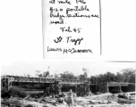 Lt. Trapp standing in front of bridge over Tenai River being built by GIs from H-20 portable bridge sections. February 1945.  Photo provided by Lewis. McCammon.