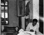 A clothing tailor working diligently in India during WWII.  Photo from Samuel J. Louff.