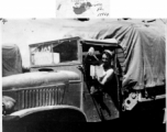 GI in driver seat of truck, with book in hand. In the CBI during WWII.  From Russell Walker.