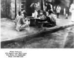 People selling something on the sidewalk in India, during WWII.  Photo from Walter Pytlowany. 