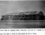 A hanger with holes from Japanese bombs in Xi'an (Hsian) Air Base during WWII.   Photo from Joe E. Ewing.