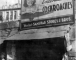 A shop with a large pesticide sign in India or Burma, during WWII.  In the CBI.