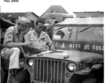 GIs strategize over the hood of a jeep in the CBI.  Photo from Paul Jones.