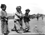 Local boys play beside road in China during WWII, in Yunnan province.