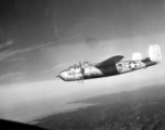 B-25H, "Wabash Cannonball", of the 491st Bomb Squadron in flight over China. Notice the 'smudge' behind the squadron emblem and below the pilot's side window. The smudge is the residue of the powder from when the side-mounted .50 caliber machine guns, are fired during a low-level attack on trains, rail yards, bridges, convoys, barges, troops, etc.  From the collection of Wozniak, combat photographer for the 491st Bomb Squadron, in the CBI.