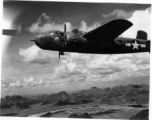 An unidentified B-25H of 491st Bm Sq in formation flight somewhere over karst formations in SW China. Photo was taken from the right, waist gun position of an aircraft.