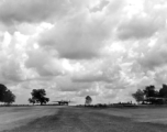 An American B-25 bomber at Yangkai, Yunnan province, in motion, while another is parked to the right. During WWII.