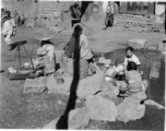 Chinese women washing either cotton or silk cocoons during WWII, in a village in China, probably in Yunnan province.  From the collection of Wozniak, combat photographer for the 491st Bomb Squadron, in the CBI.