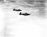 Two B-25Ds of the 491st Bm Sq fly above a solid cloud layer.  Running out of fuel because clouds hid the air fields caused more aircraft losses in China than did the enemy aircraft or anti-aircraft fire.