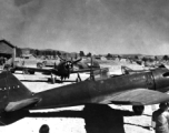 A captured Japanese A6M2 "Zeke", re-painted in Chinese Air Force (CAF) colors, with Chinese serial 'P5016'.  The aircraft directly behind the 'Zeke' is a P-43 "Lancer" flown by the CAF.  The aircraft are probably at Kunming--because of  the 23 Fighter Group P-40 in the background on the right.  (information provided by Tony Strotman)