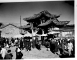 Local people in Yunnan province, China: A busy gate and market area. During WWII.