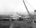 "Here is a picture of Sgt. Miller and Sgt.Blumer's salvage vehicle at work picking up a P-51 that had to make a gear-up landing."