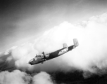 B-25 Mitchell bomber #448 in flight in the CBI, in the area of southern China, Indochina, or Burma.