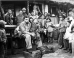At the hardware stand, GI Fred Nash, with appreciative local people. Yangkai Village, Spring 1945.