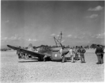 A P-40, tail #264, down on its belly in Guilin, likely a 26th Fighter Squadron "China Blitzers" P-40K. Emblem painted on cowling prior to the application of a sharkmouth."    (Thanks for additional info from jbarbaud.)  From the collection of Hal Geer.