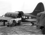 A C-46 cargo plane of the Air Transport Command (ATC), tail number #296779, being unloaded (or loaded) in China during WWII.