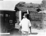 A medical orderly walks by an ambulance in Guangxi province, China, during WWII.