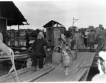 People crossing the floating bridge at Liuzhou during WWII.