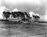 Chinese farmers work in fields outside an American air base in SW China during WWII.