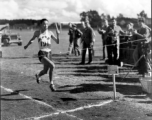 A runner crosses the finish line at a track meet in China during WWII, on October 23, 1944.