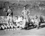Lemmon, unkn0wn, Red Cummings, Peterson, Gibbs. Arming 100 lb. bombs, and goofing for the camera at the same time, in a revetment. During WWII.  Probably at Yangkai.