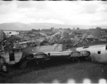 A bone yard of wrecked American military aircraft during WWII at Luliang, Yunnan province, China, looking east.  In this image are easily recognized C-46 and B-24 air frames.