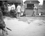 Some commotion around man on ground on street in Yunnan, during WWII.