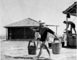 Laborer at an American air base carrying pails--they may not have smelled nice--in the CBI.