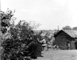 Row of vehicles, and Chinese soldiers with equipment ready and covered in camouflage during exercises in southern China, in Yunnan province.  Despite the appearance of being on their way to battle, these men are more likely in fact prepared for a demonstration or honor parade. 