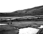 Rural farming countryside with rice paddies in China, probably in Yunnan province. During WWII.