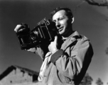 Eugene T. Wozniak, combat photographer for the 491st Bomb Squadron, with a Speed Graphic camera in Yunnan, China, during WWII.