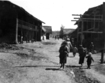 People go about lives in small township in China during WWII.