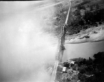 B-25 Mitchell bombers have just bombed a railroad bridge a bridge somewhere in southwest China, Indochina, or Burma, leading to no apparent damage, but a large cloud of dust and smoke. 