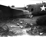 Wrecked B-25 Mitchell bomber on the ground in the CBI. The wreck was apparently at an air base, and probably on take-off, as the craft is sprayed with fire-retardant foam, and bombs are scattered about the wreck site. During WWII.