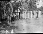 Solemn burial ceremony for American GIS who had died at a temporary war-time graveyard. In the CBI, during WWII.