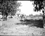 Solemn burial ceremony for American GIS who had died at a temporary war-time graveyard. In the CBI, during WWII.