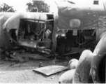 Wrecked B-25 Mitchell bomber on the ground in the CBI. The wreck was apparently at an air base, and probably on take-off, as the craft is sprayed with fire-retardant foam, and bombs are scattered about the wreck site. During WWII.